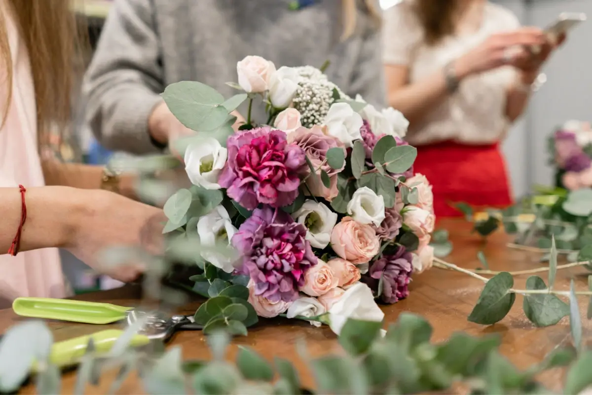 Florist's hands carefully crafting a bouquet