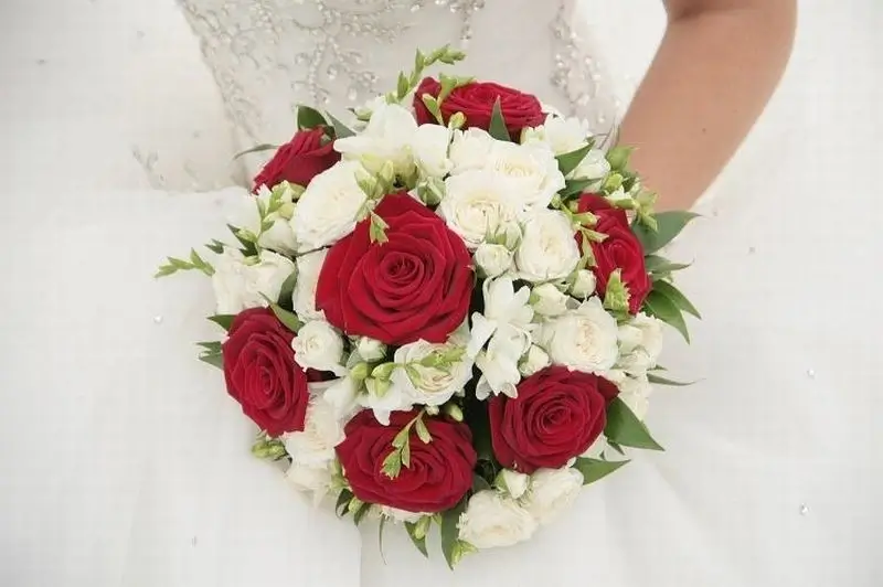 A rustic bouquet with deep red and white flowers