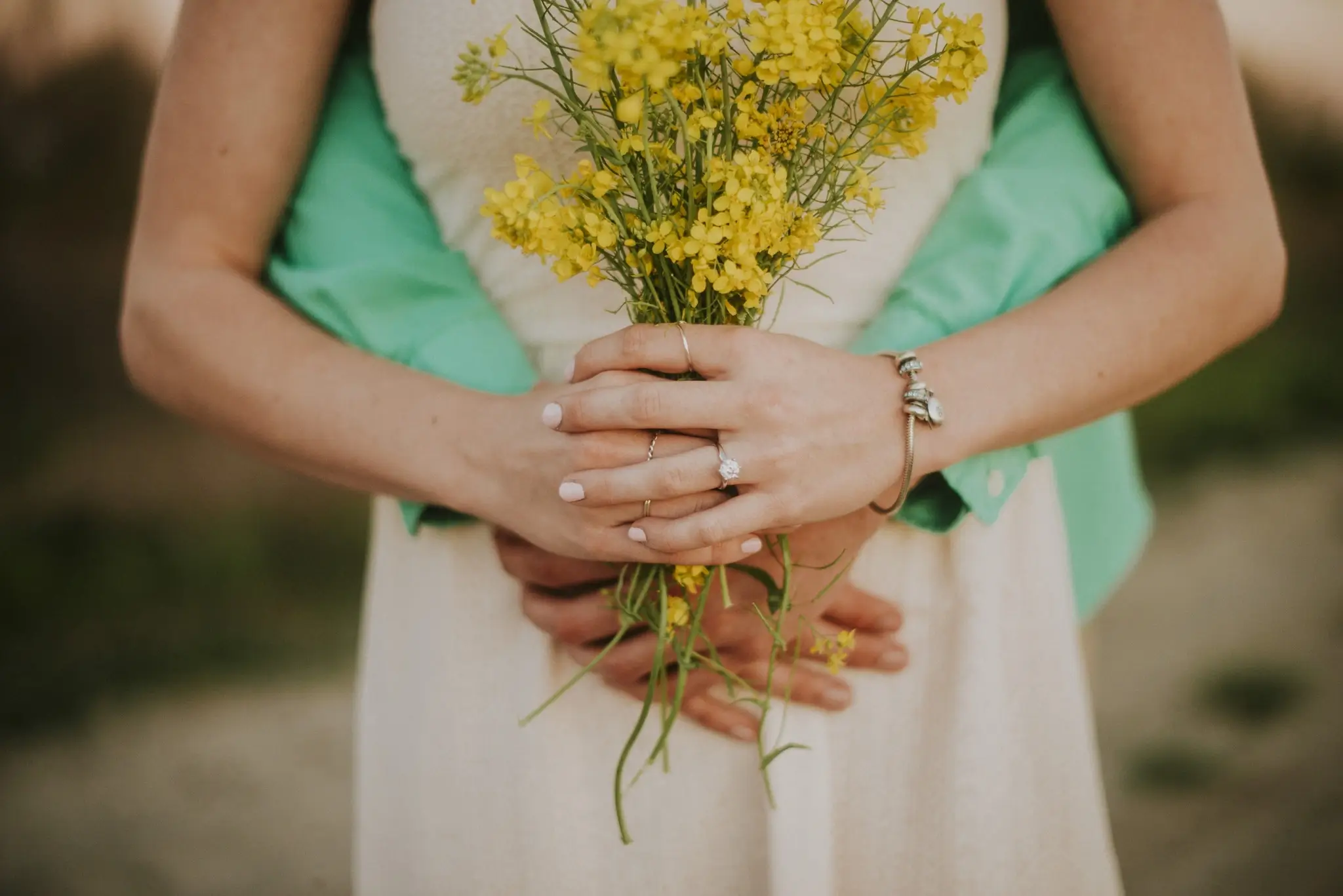 Hands exchanging a bouquet of locally grown flowers
